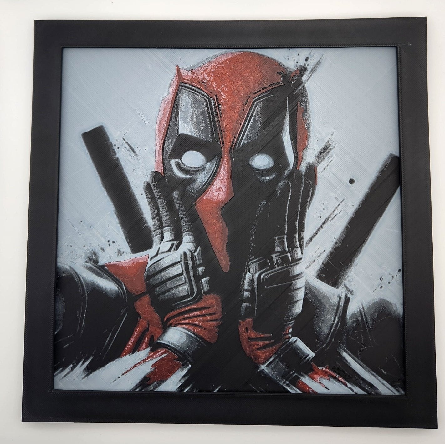 picture of deadpool with a shocked face in a black frame